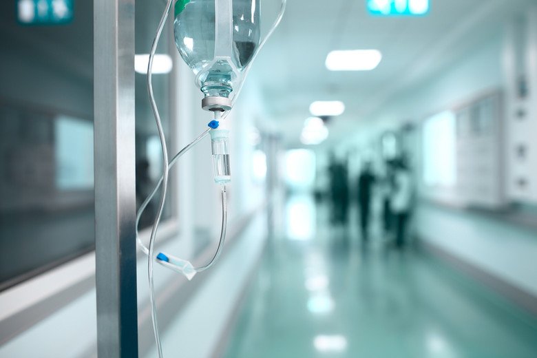 an emergency corridor in a hospital with an IV (intravenous device) in the foreground