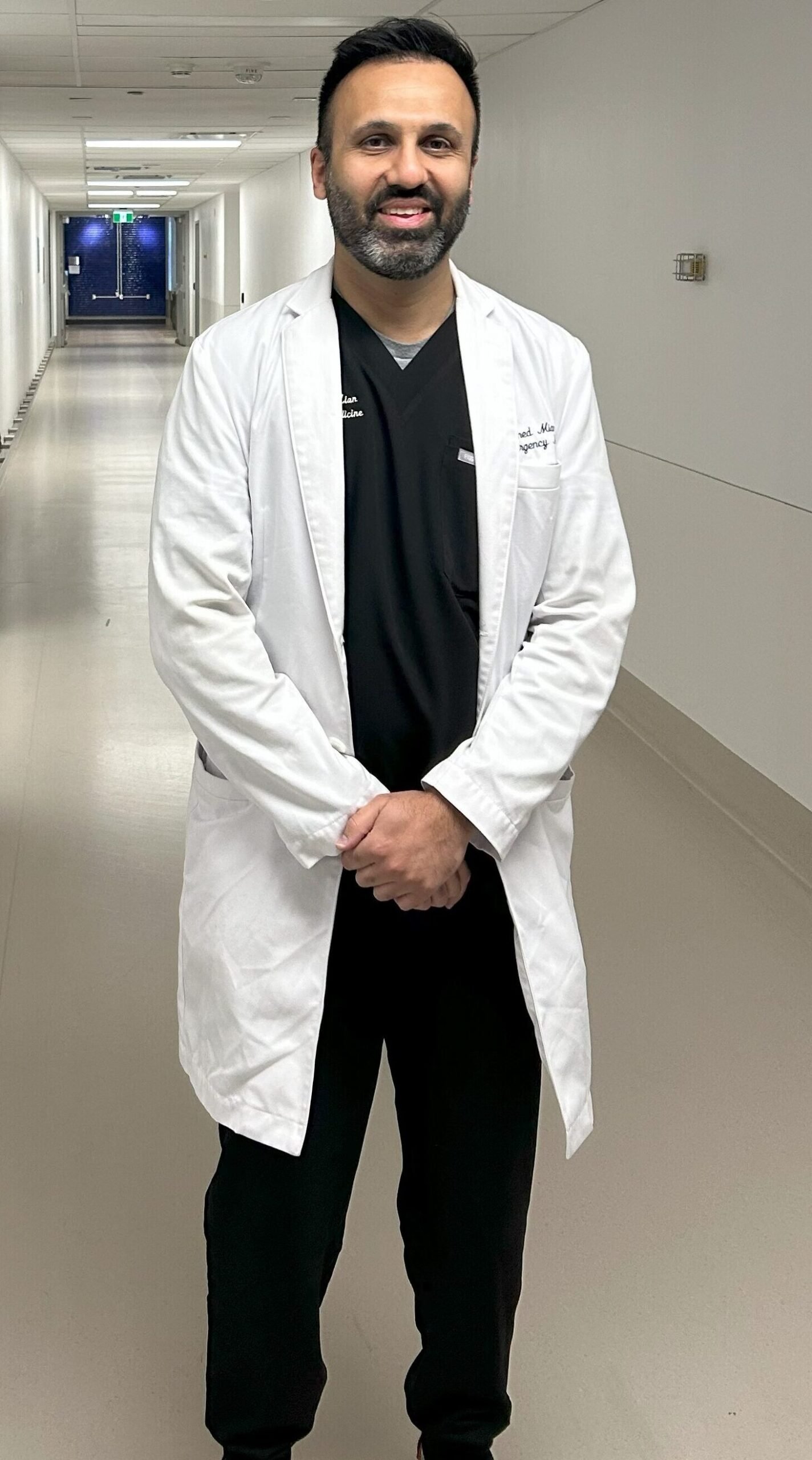 Dr. Ahmed Mian standing in an Emergency hospital hallway